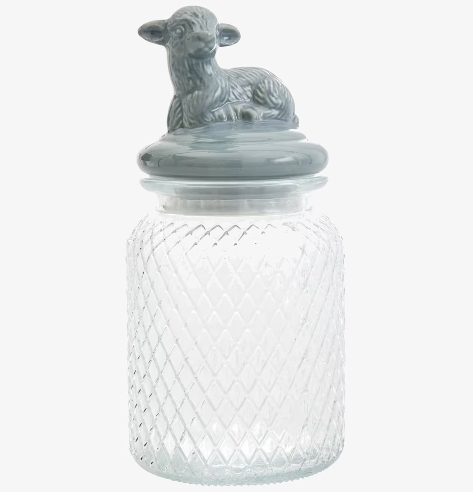 Foto av glasburk med dekorativt lamm på locket