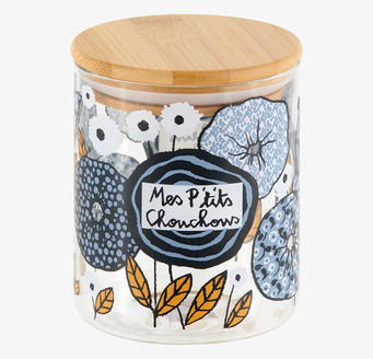 Bild av glasburk med trälock och blommigt motiv