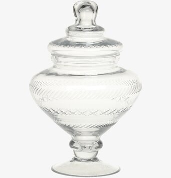 Bild av elegant glaskruka på fot med dekorativ design