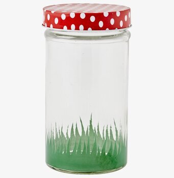 Bild av glasburk med färgglatt lock och grön bas